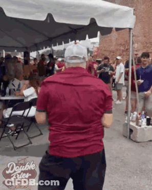 Man In Red Shirt In Front Of Double Fries Tent GIF