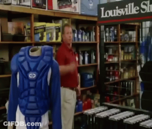 Man In Red Shirt In Front Of Louisville Sign GIF