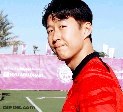 Man In Red Shirt In Front Of NYU Abu Dhabi GIF