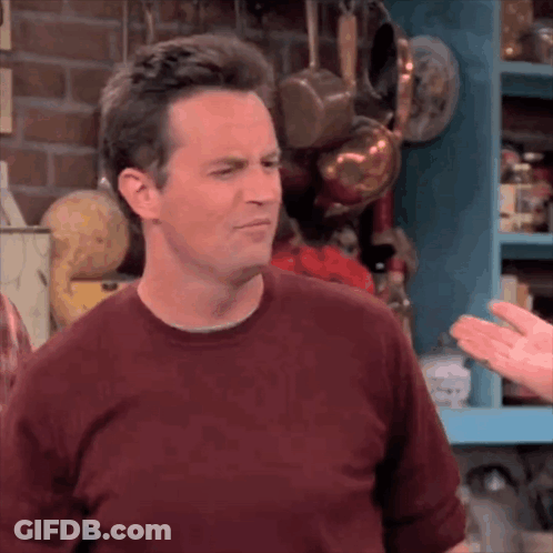 Man In Red Shirt In Front Of Shelf With Pots And Pans GIF
