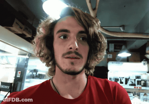 Man In Red Shirt In Front Of Sony Display GIF