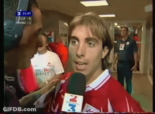 Man In Red Shirt Interviewed By Man With Microphone 3 GIF