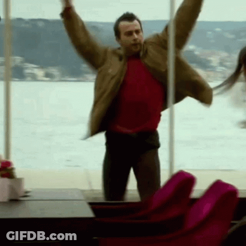 Man In Red Shirt Jumping Arms Out GIF