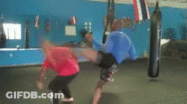 Man In Red Shirt Kicking Man In Blue Shirt GIF