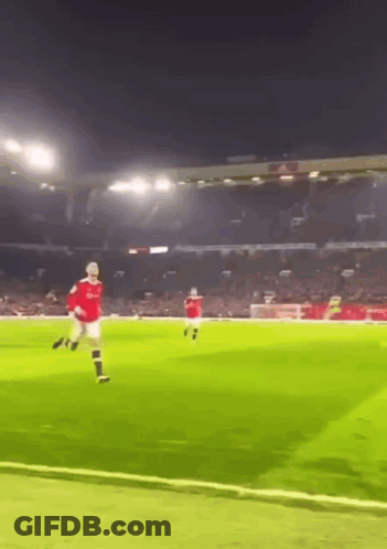 Man In Red Shirt Kicking Soccer Ball GIF