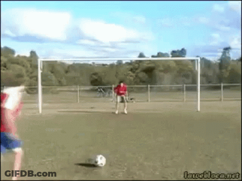 Man In Red Shirt Kicking Soccer Ball GIF