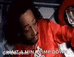 Man In Red Shirt Laying On Bed Saying Wait A Min Pimp Down GIF