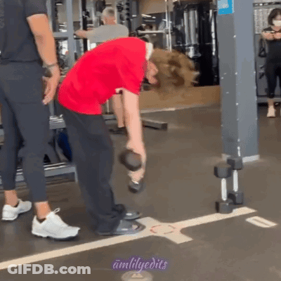Man In Red Shirt Lifting Dumbbell While Another Man Watches GIF