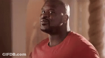 Man In Red Shirt Looking At Camera GIF