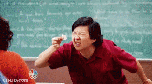 Man In Red Shirt Making Funny Face In Classroom GIF