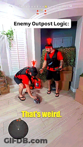 Man In Red Shirt Next To Man In Black Vest GIF