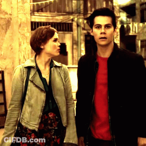 Man In Red Shirt Next To Woman In White Jacket GIF