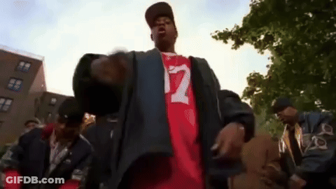 Man In Red Shirt Number 12 Standing Before Crowd GIF