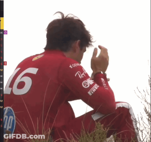 Man In Red Shirt Number 16 Sitting In Grass GIF