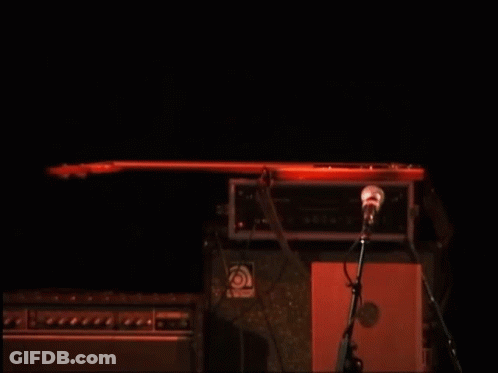 Man In Red Shirt Playing Guitar At Microphone GIF