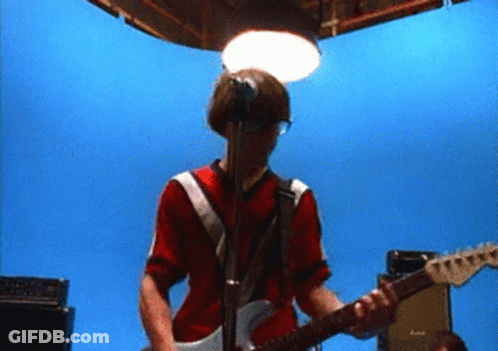Man In Red Shirt Playing Guitar At Microphone GIF