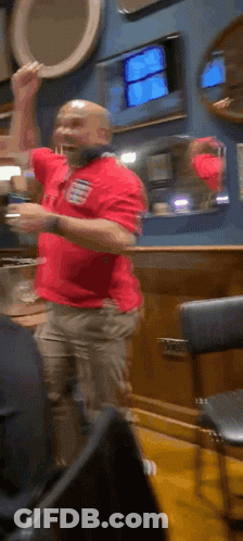 Man In Red Shirt Playing Guitar In Front Of Microphone GIF