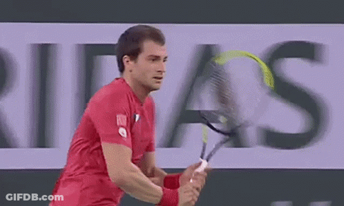 Man In Red Shirt Playing Tennis With Ribas Ad GIF