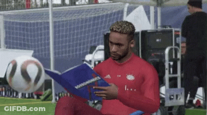 Man In Red Shirt Reading Rossonomics GIF