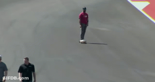 Man In Red Shirt Riding Skateboard GIF