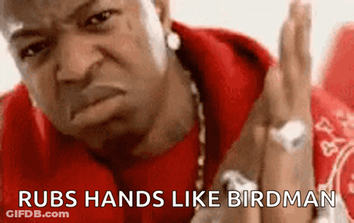 Man In Red Shirt Rubs Hands Like Birdman GIF