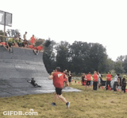 Man In Red Shirt Running Across Field GIF