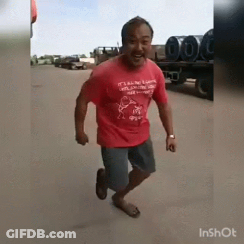 Man In Red Shirt Running Down Road GIF
