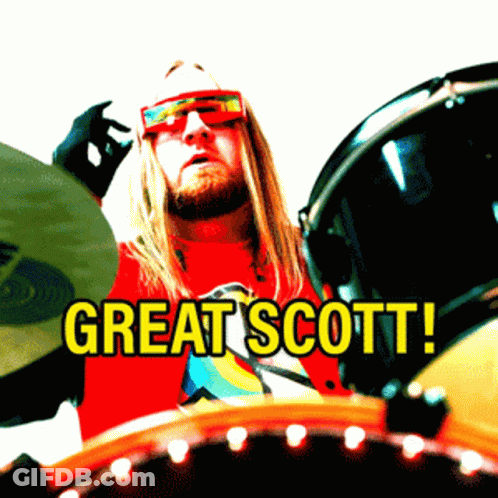 Man In Red Shirt Saying Great Scott Playing Drums GIF