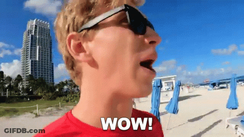 Man In Red Shirt Saying Wow On Beach GIF