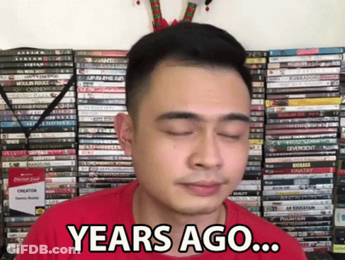 Man In Red Shirt Saying Years Ago In Front Of DVDs GIF