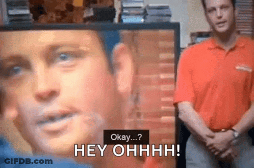 Man In Red Shirt Says Okay At Screen With Face GIF