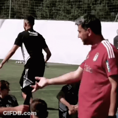 Man In Red Shirt Shaking Hands With Soccer Player GIF
