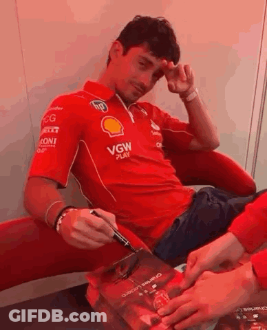 Man In Red Shirt Signing Book GIF