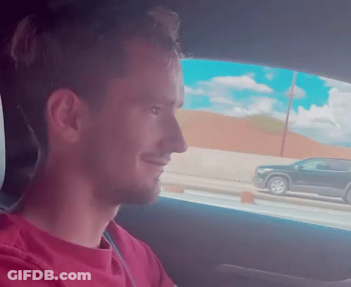 Man In Red Shirt Sitting In Driver Seat GIF