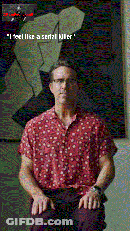 Man In Red Shirt Sitting In Front Of Painting GIF