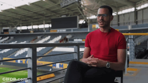 Man In Red Shirt Sitting On Balcony GIF