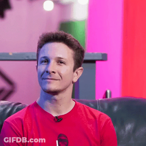 Man In Red Shirt Sitting On Black Couch GIF