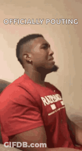 Man In Red Shirt Sitting On Couch Head Down GIF