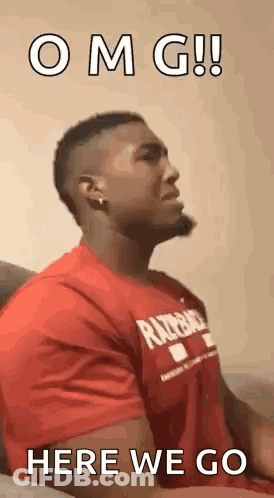Man In Red Shirt Sitting On Couch Making Face GIF