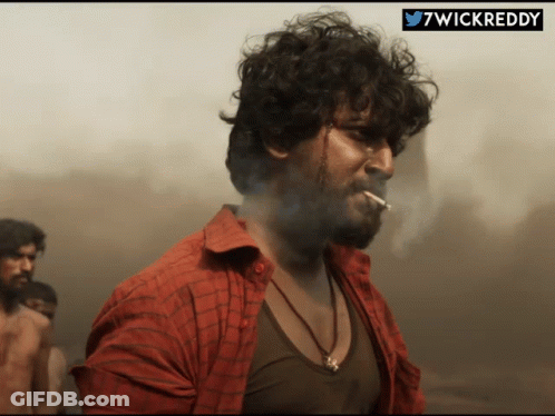 Man In Red Shirt Smoking With Hashtag 7Wickreddy GIF