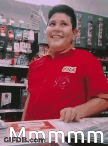 Man In Red Shirt Standing At Store Counter GIF