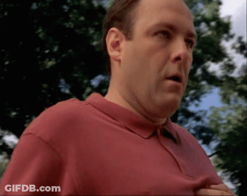 Man In Red Shirt Standing Before Trees GIF