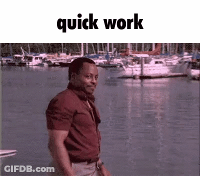 Man In Red Shirt Standing By Water With Boats GIF