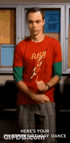 Man In Red Shirt Standing In Front Of Bulletin Board GIF