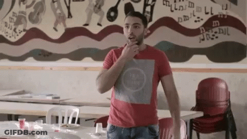 Man In Red Shirt Standing In Front Of Mural GIF
