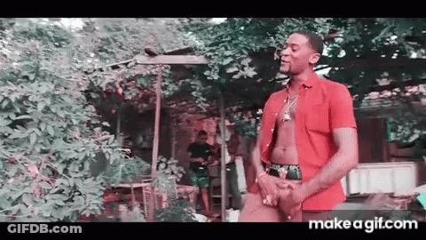 Man In Red Shirt Standing In Front Of Tree GIF