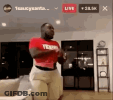 Man In Red Shirt Standing In Living Room GIF
