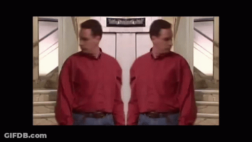 Man In Red Shirt Standing Next To Another Man GIF