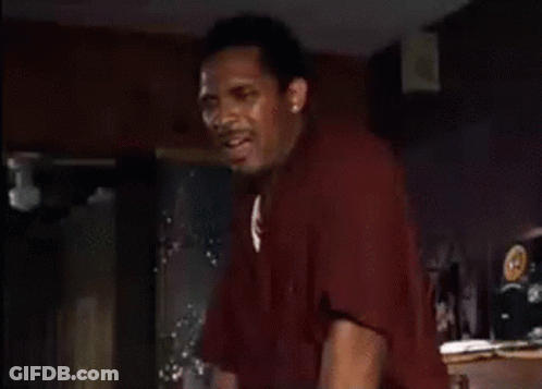 Man In Red Shirt Standing With Hands Up GIF
