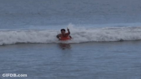 Man In Red Shirt Surfing Ocean GIF
